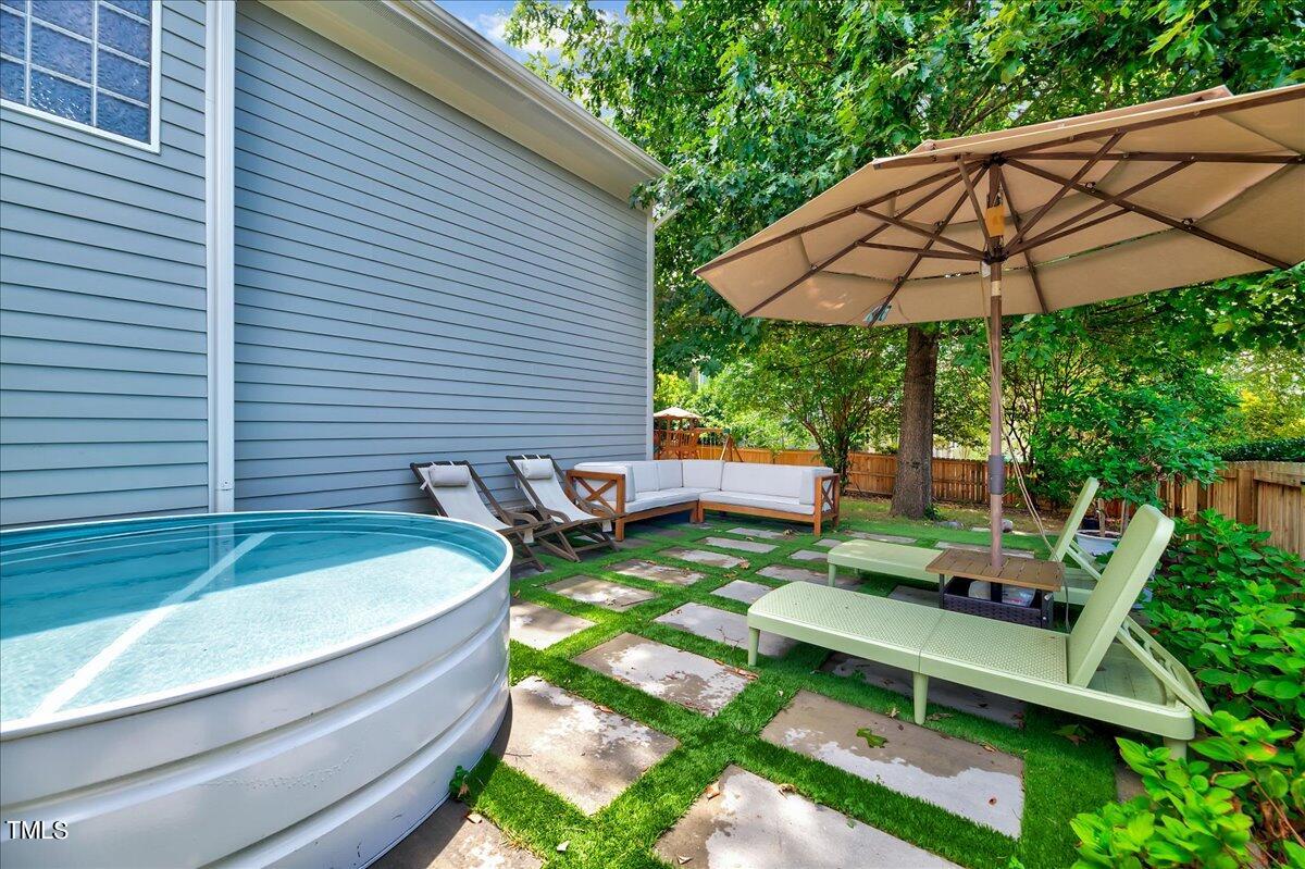 2901 Brighton Bluff Drive Apex, NC 27539 - Photo 29 of 35 a view of a backyard with chairs and a patio
