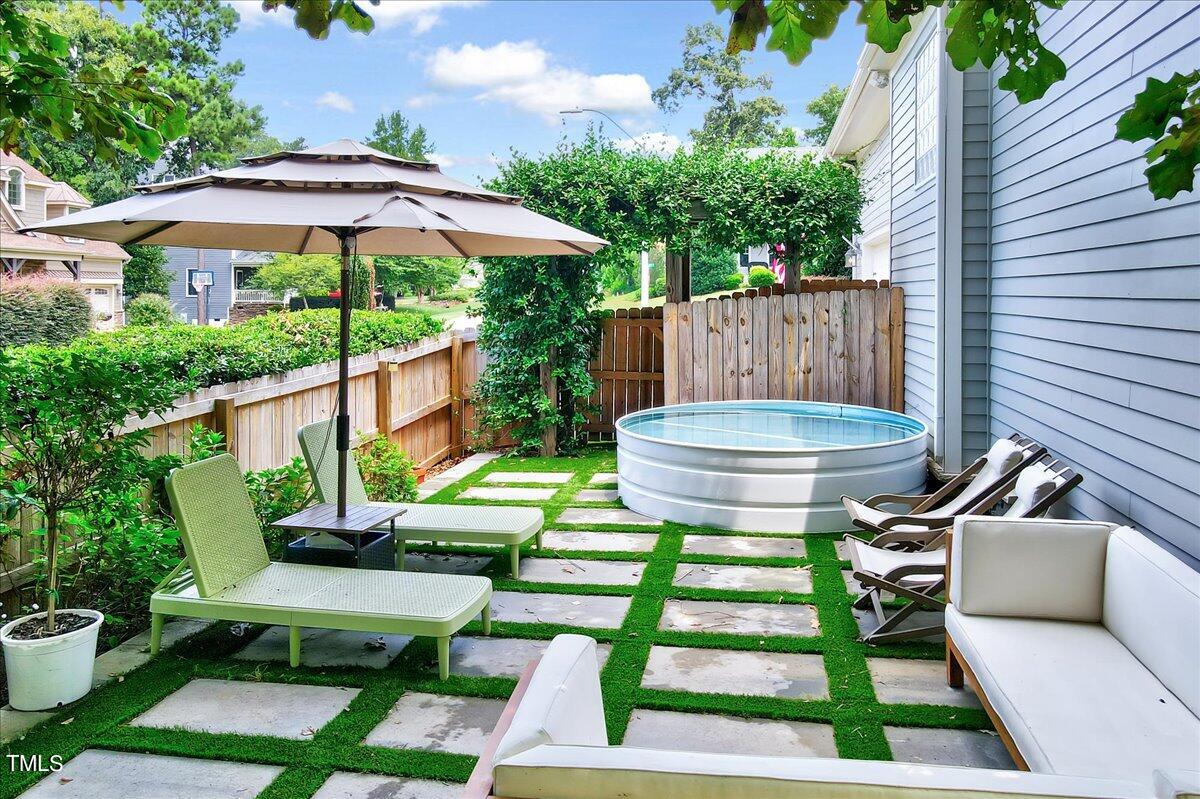 2901 Brighton Bluff Drive Apex, NC 27539 - Photo 30 of 35 a view of a chair and table in backyard