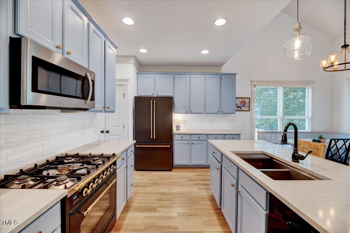 2901 Brighton Bluff Drive Apex, NC 27539 - Photo 5 of 35 a kitchen with stainless steel appliances a stove sink microwave and refrigerator