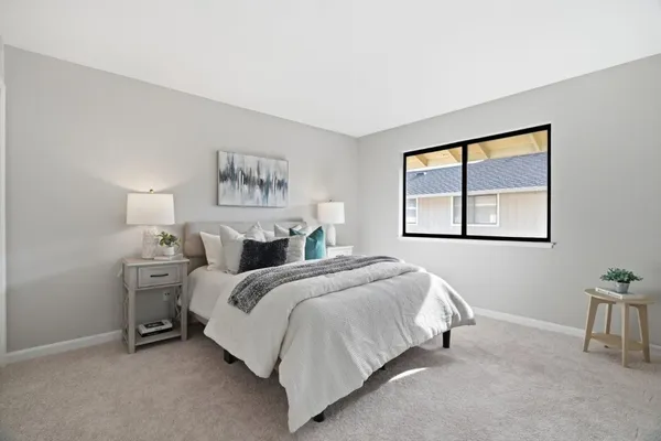 a spacious bedroom with a bed and a window