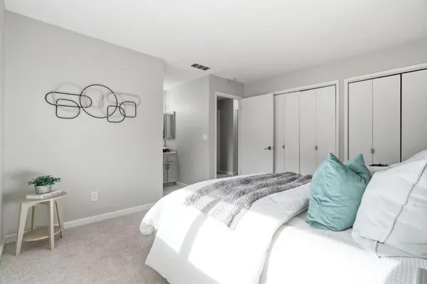 a bedroom with a bed and a table