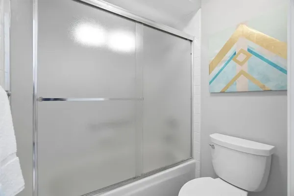 a white toilet sitting next to a bathroom sink