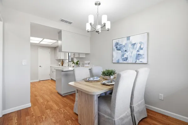 a view of a dining room with furniture and wooden floor