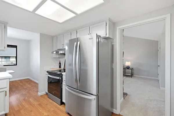 a kitchen with stainless steel appliances a refrigerator and a stove top oven