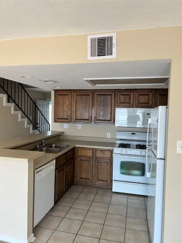 a kitchen with stainless steel appliances granite countertop a stove and a sink