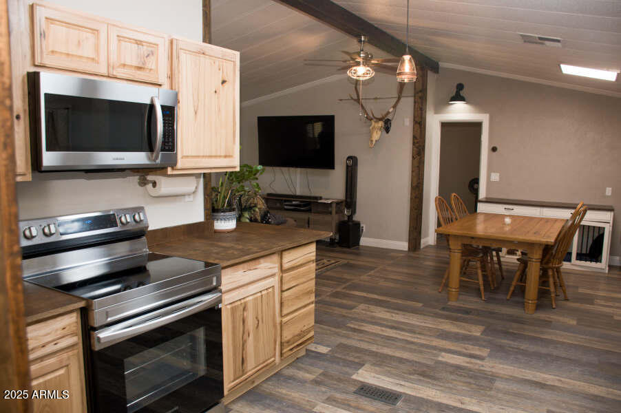 200 North Tomahawk Road Apache Junction, AZ 85119 - Photo 12 of 56 a kitchen with stainless steel appliances a stove microwave and sink