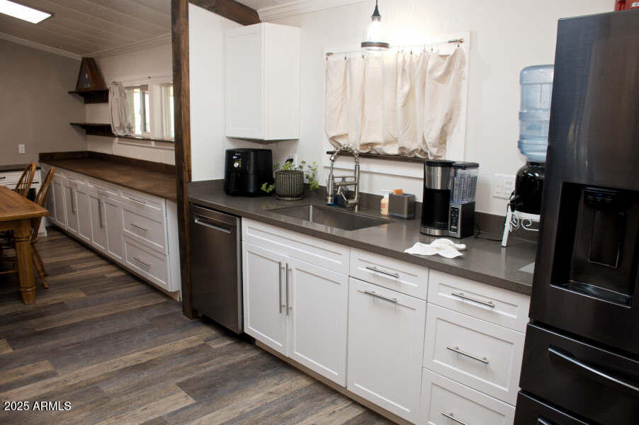 200 North Tomahawk Road Apache Junction, AZ 85119 - Photo 14 of 56 a kitchen with appliances a sink and cabinets