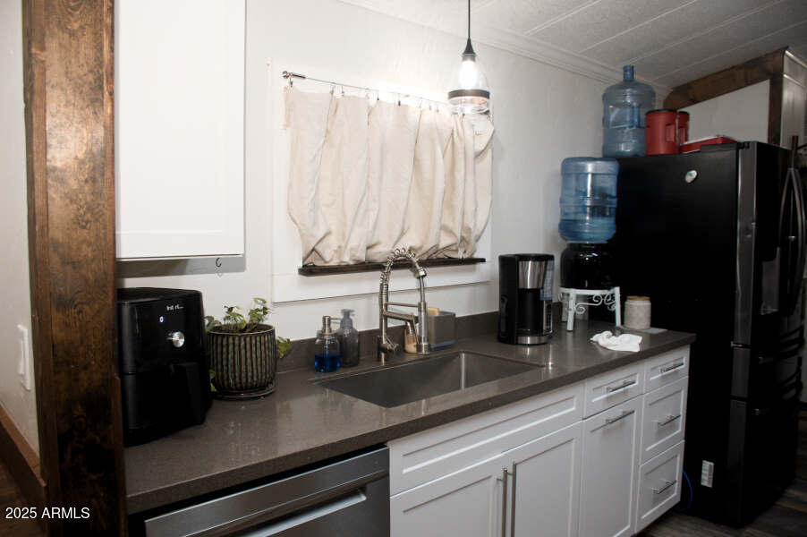 200 North Tomahawk Road Apache Junction, AZ 85119 - Photo 16 of 56 a kitchen with appliances a sink and cabinets