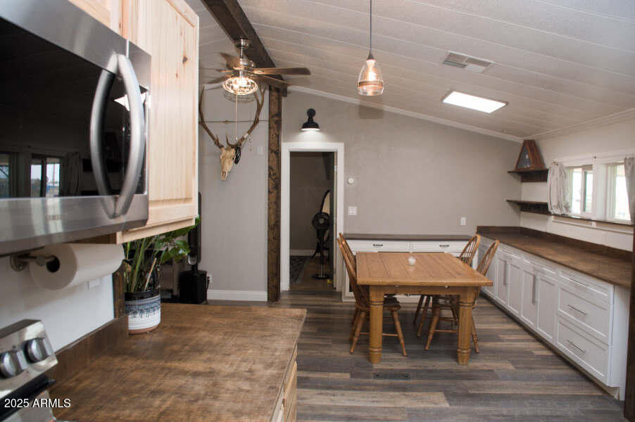 200 North Tomahawk Road Apache Junction, AZ 85119 - Photo 17 of 56 a kitchen with stainless steel appliances granite countertop a dining table chairs refrigerator and sink