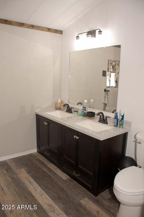 200 North Tomahawk Road Apache Junction, AZ 85119 - Photo 31 of 56 a bathroom with a sink vanity mirror and toilet