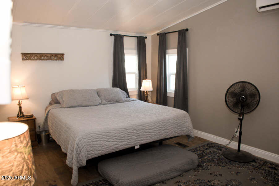 200 North Tomahawk Road Apache Junction, AZ 85119 - Photo 34 of 56 a bedroom with a bed a lamp and a large window