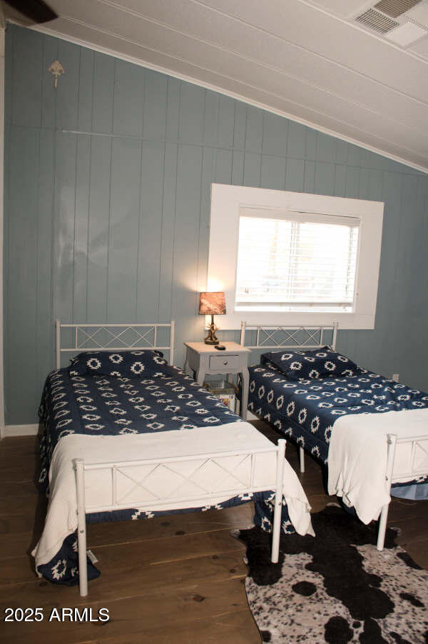 200 North Tomahawk Road Apache Junction, AZ 85119 - Photo 37 of 56 a bedroom with a bed and wooden floor