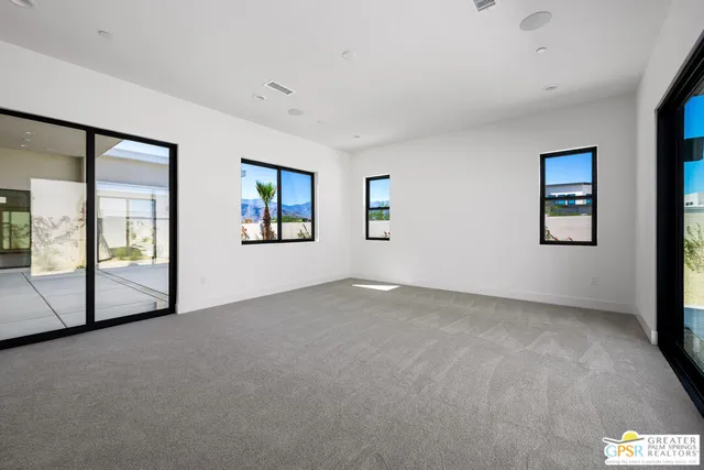 a view of a big room with windows and closet
