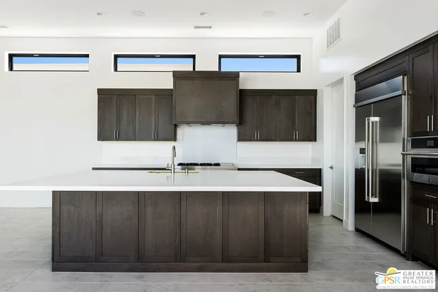 a kitchen with stainless steel appliances a refrigerator and a microwave