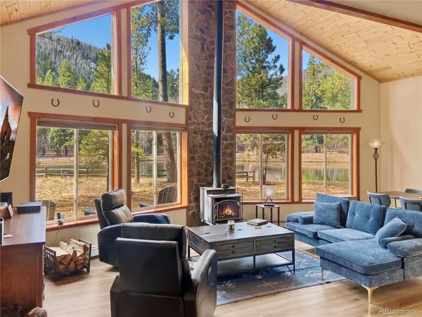 a living room with furniture and large windows