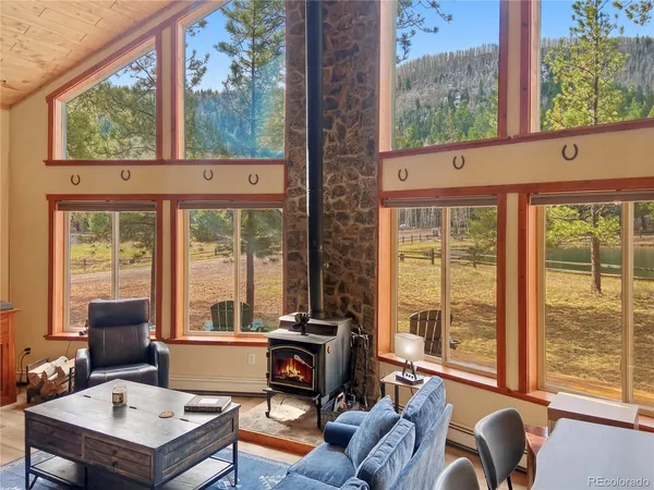 a living room with furniture and a floor to ceiling window