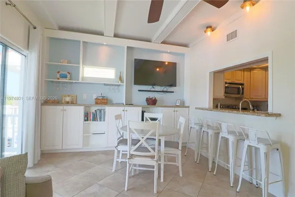 a kitchen with stainless steel appliances granite countertop white cabinets and a stove top oven
