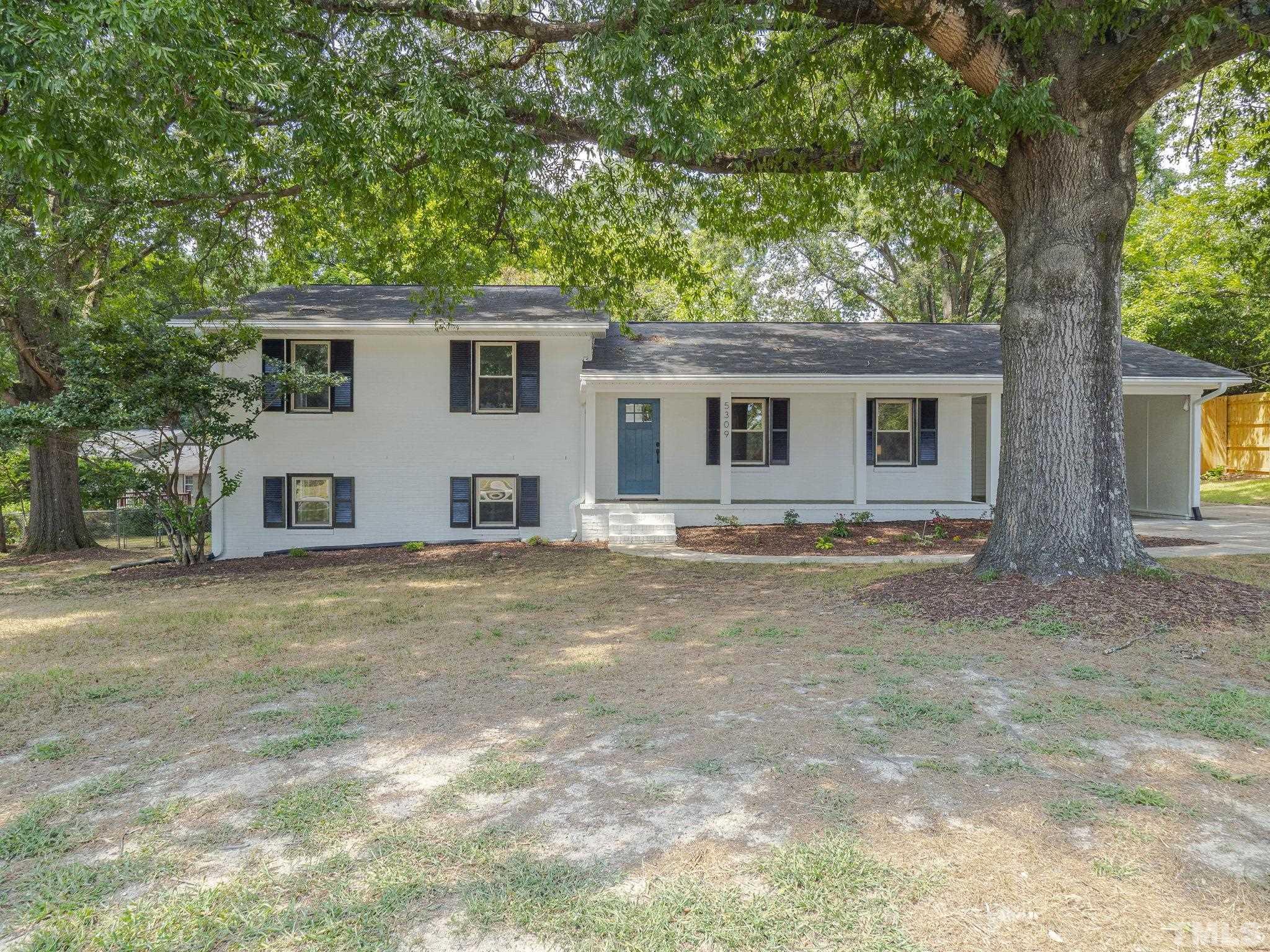 5309 Knollwood Road Raleigh, NC 27609 - Photo 1 of 19 a view of a house with a backyard and a tree