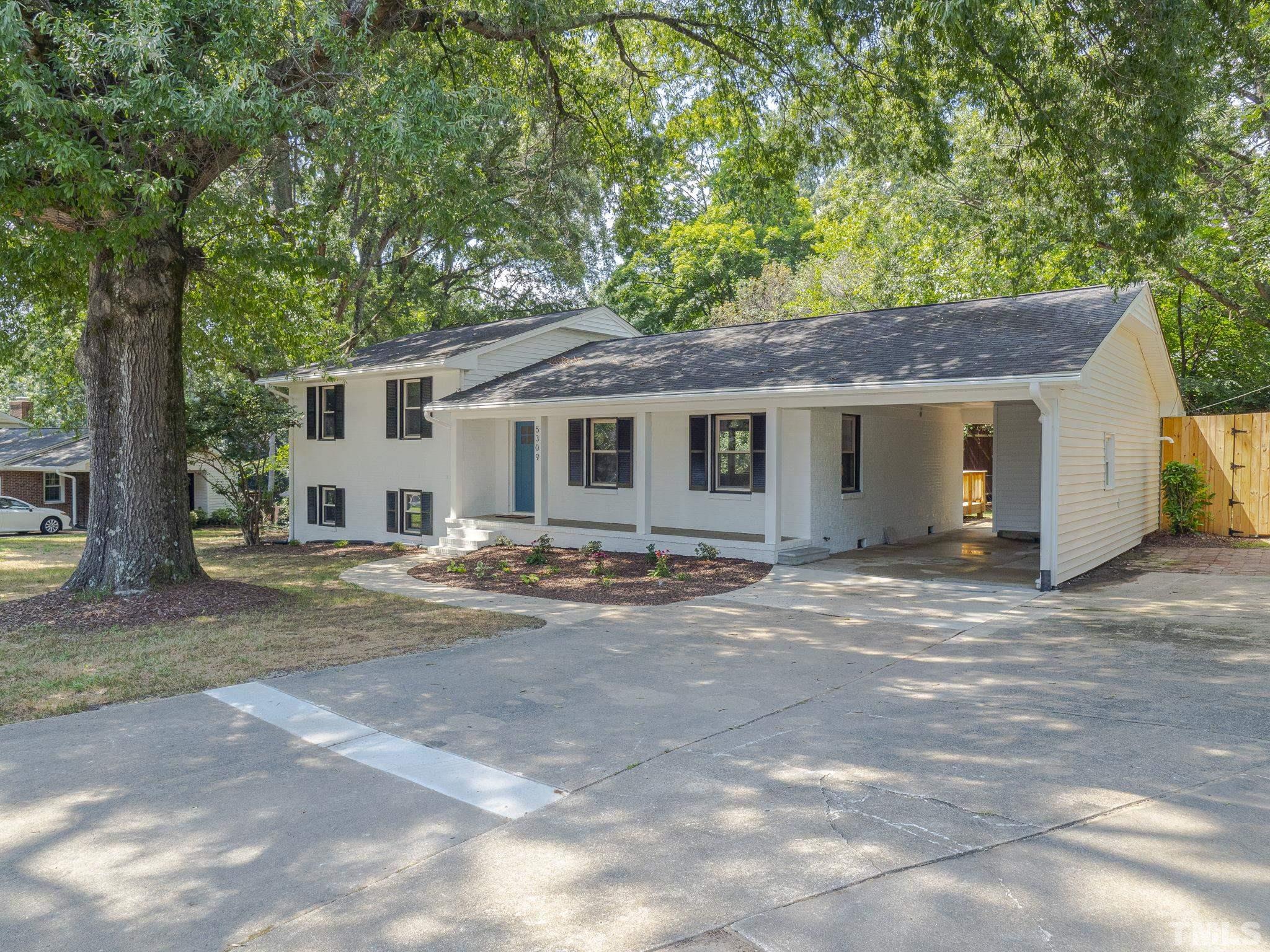 5309 Knollwood Road Raleigh, NC 27609 - Photo 2 of 19 a view of a yard in front of a house with large tree