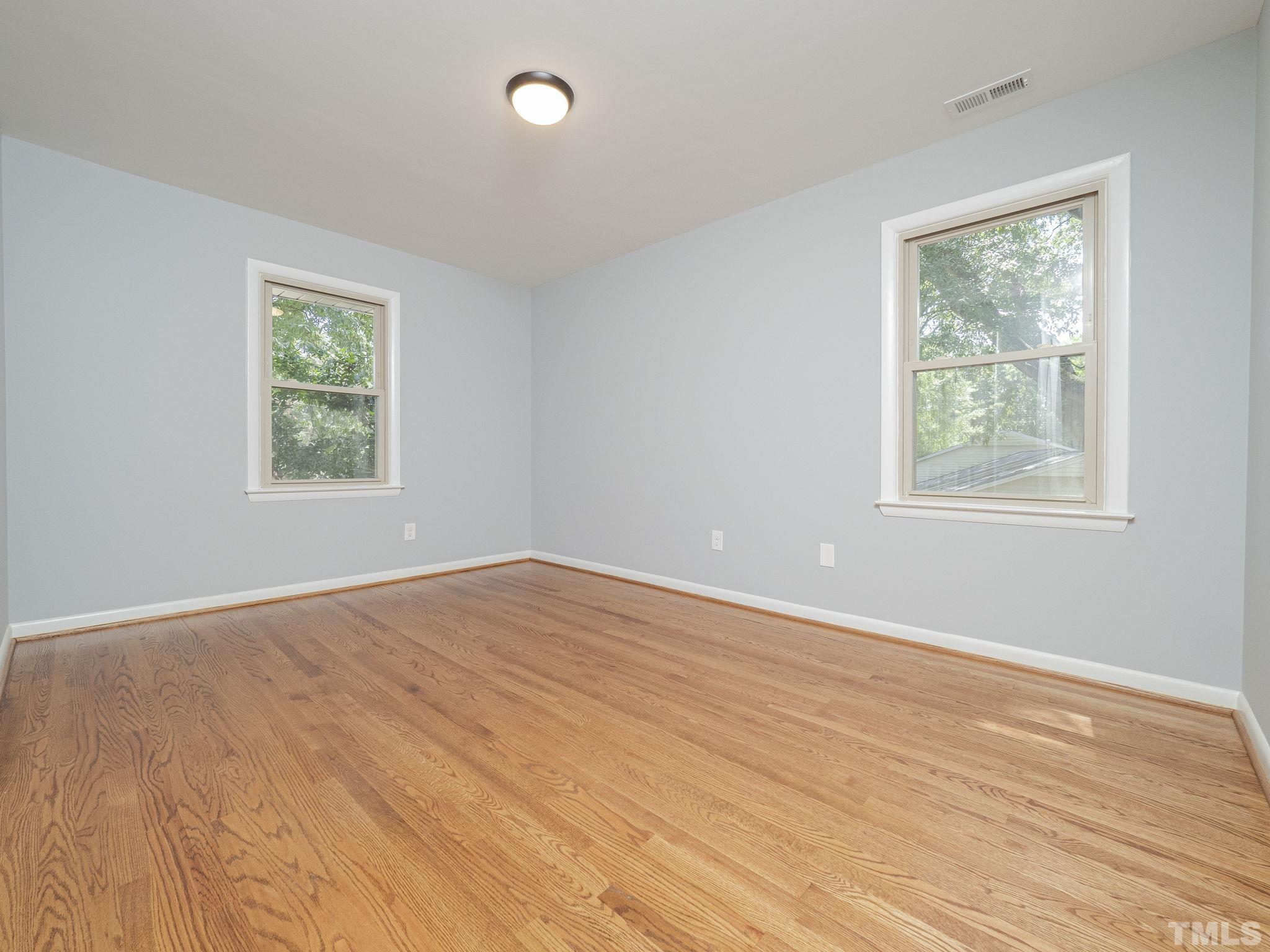 5309 Knollwood Road Raleigh, NC 27609 - Photo 11 of 19 a view of an empty room with wooden floor and a window