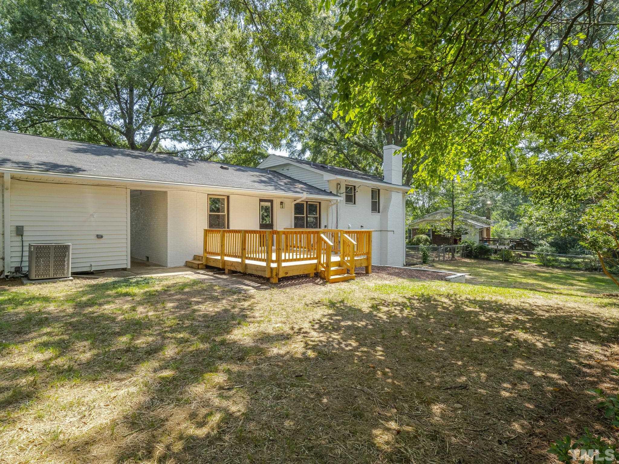 5309 Knollwood Road Raleigh, NC 27609 - Photo 17 of 19 a house with trees in front of it