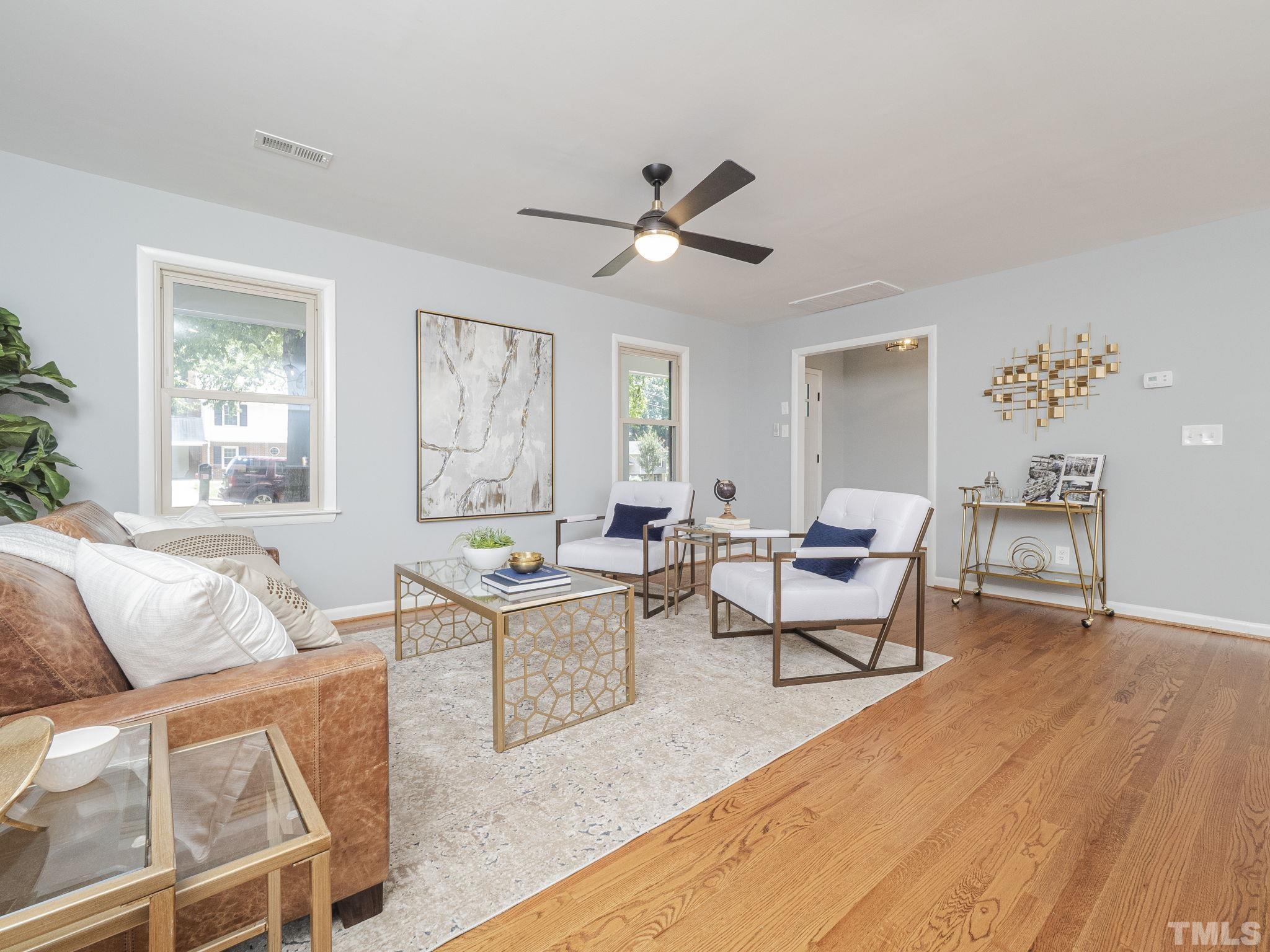5309 Knollwood Road Raleigh, NC 27609 - Photo 5 of 19 a living room with furniture a ceiling fan and a window