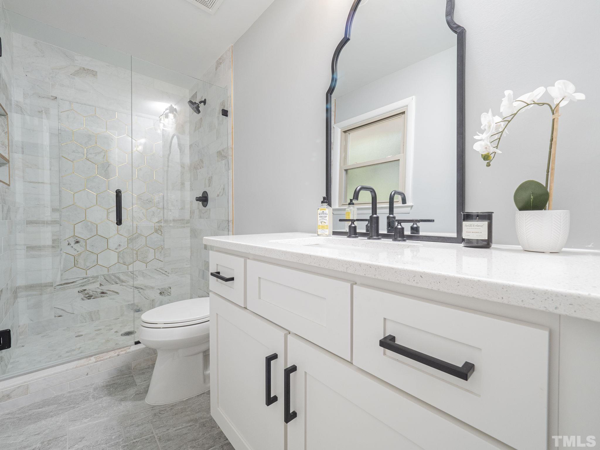 5309 Knollwood Road Raleigh, NC 27609 - Photo 10 of 19 a bathroom with a sink a toilet and shower