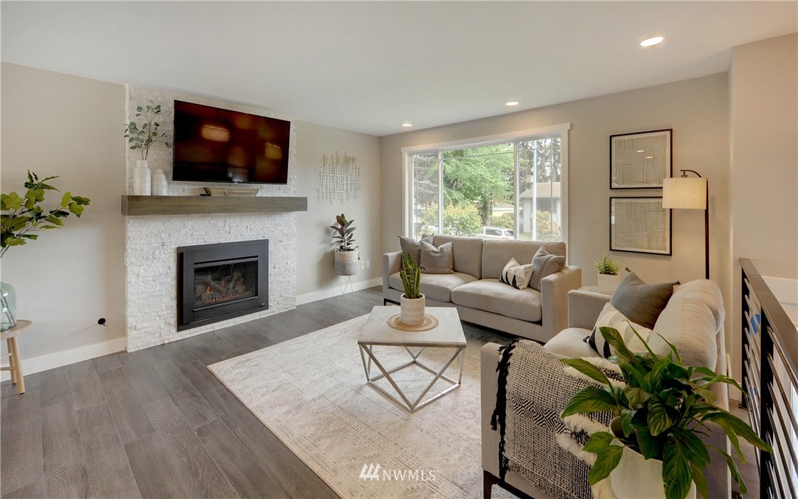 31 218th Place Southwest Bothell, WA 98021 - Photo 3 of 26 a living room with furniture fireplace and a flat screen tv