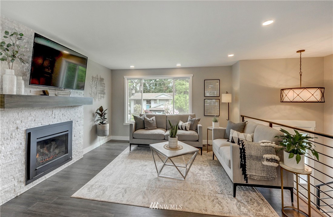 31 218th Place Southwest Bothell, WA 98021 - Photo 4 of 26 a living room with furniture a flat screen tv and a fireplace