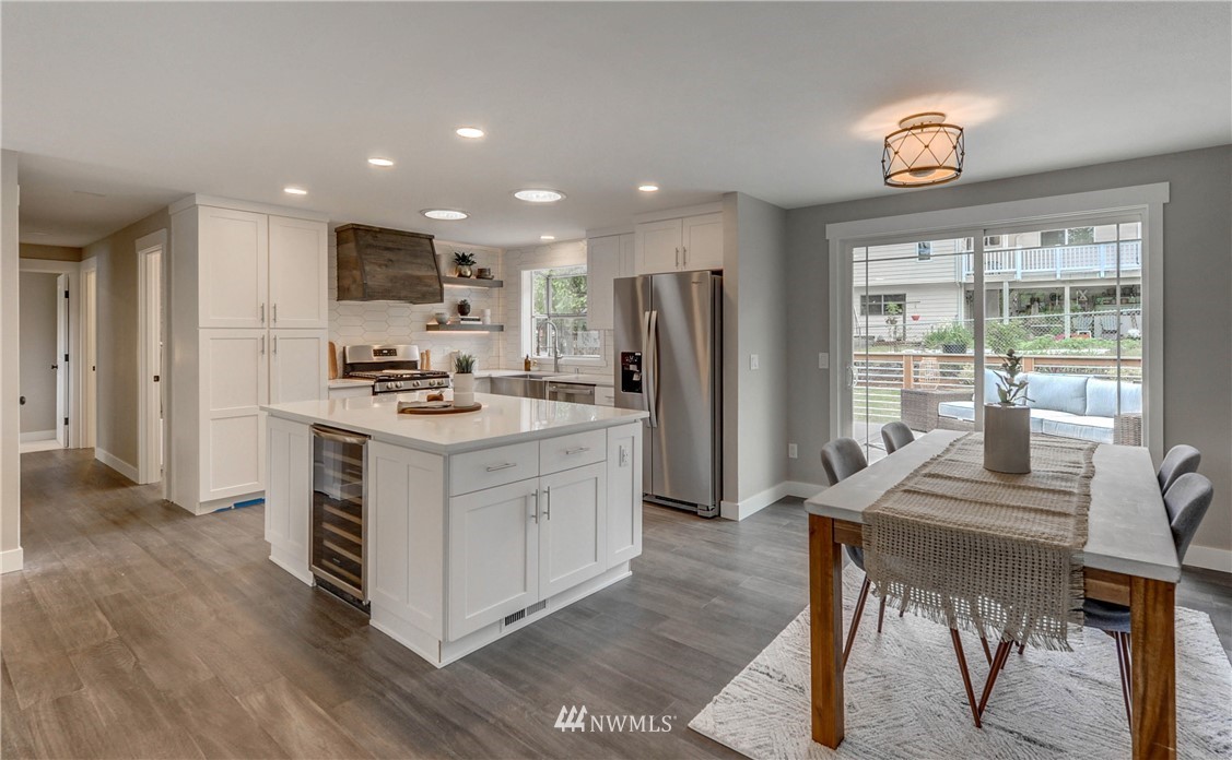 31 218th Place Southwest Bothell, WA 98021 - Photo 6 of 26 a kitchen with a refrigerator a stove cabinets dining table and chairs