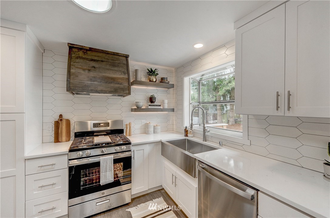 31 218th Place Southwest Bothell, WA 98021 - Photo 10 of 26 a kitchen with a stove and a sink