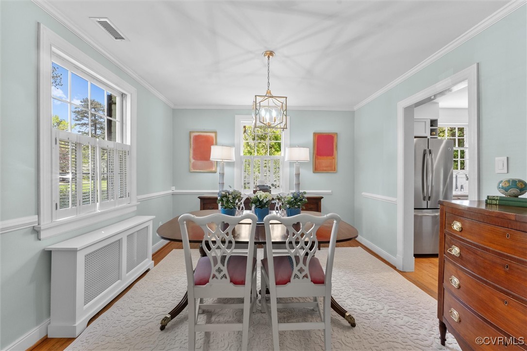 1210 Skipwith Road Henrico, VA 23229 - Photo 17 of 32 a dining room with furniture a chandelier and window