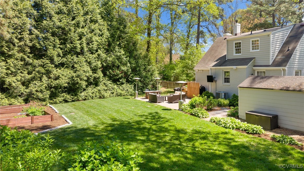 1210 Skipwith Road Henrico, VA 23229 - Photo 5 of 32 a backyard of a house with a garden and plants