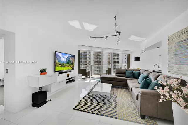 a living room with furniture a flat screen tv and a fireplace