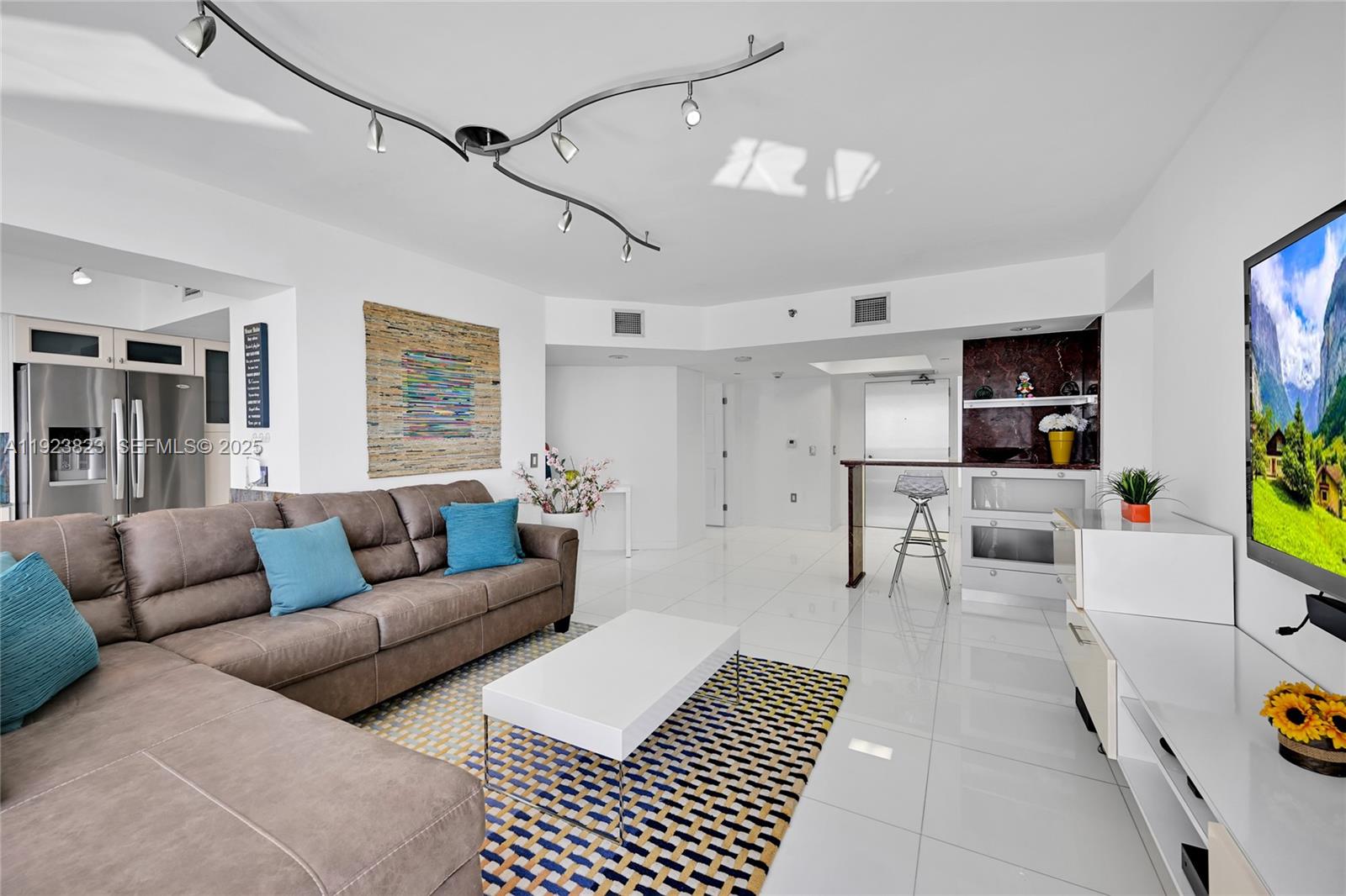 16445 Collins Avenue, Unit 2228 Sunny Isles Beach, FL 33160 - Photo 3 of 36 a living room with furniture and view of kitchen