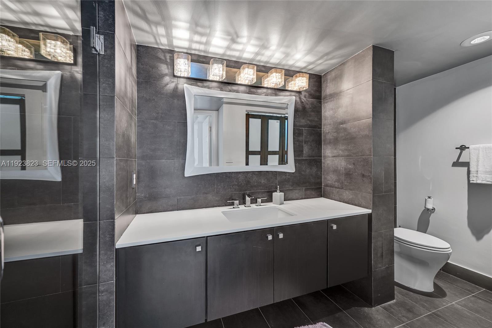 16445 Collins Avenue, Unit 2228 Sunny Isles Beach, FL 33160 - Photo 34 of 36 a bathroom with a sink a toilet and shower