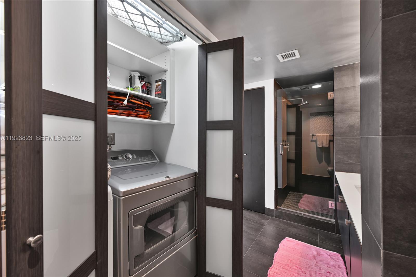 16445 Collins Avenue, Unit 2228 Sunny Isles Beach, FL 33160 - Photo 35 of 36 a storage room with washer and dryer