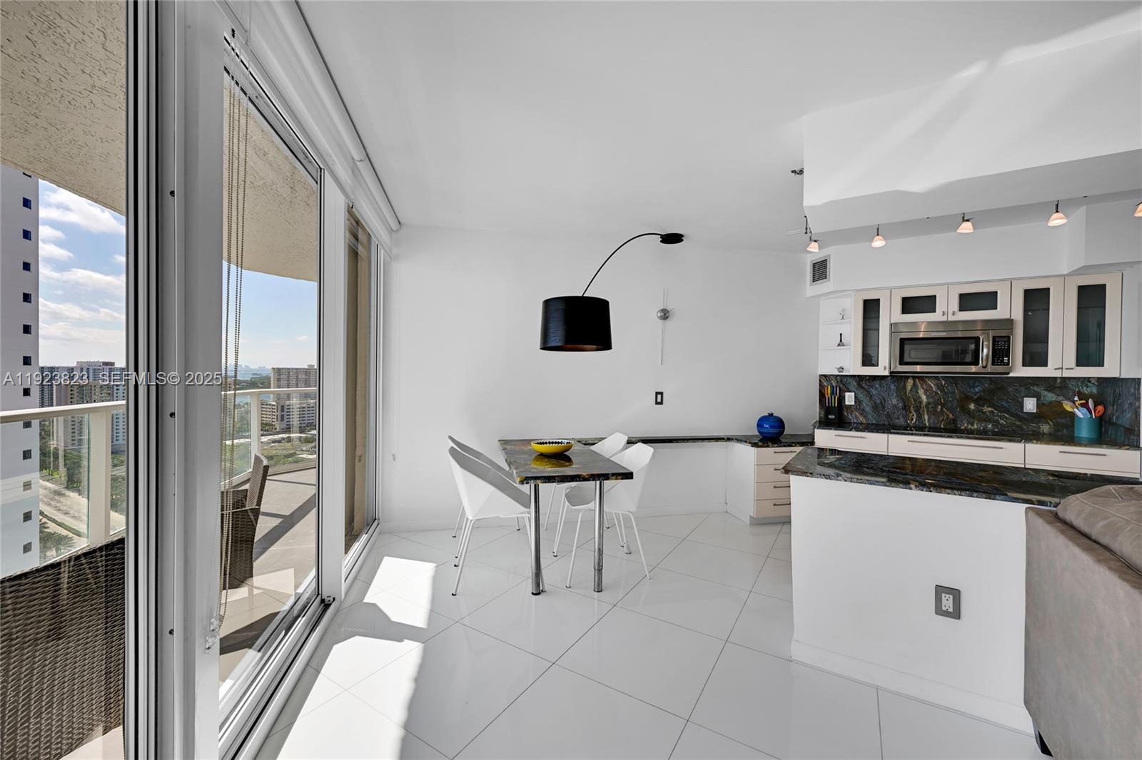 16445 Collins Avenue, Unit 2228 Sunny Isles Beach, FL 33160 - Photo 8 of 36 a kitchen with stainless steel appliances a stove a sink and a refrigerator
