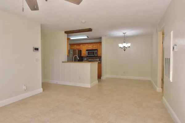 a view of a hallway to rooms and wooden floor