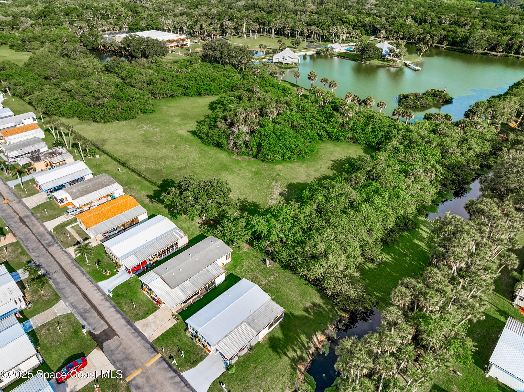 0 South John Rodes Boulevard Melbourne, FL 32934 - Photo 14 of 14 an aerial view of a house with a garden and lake view