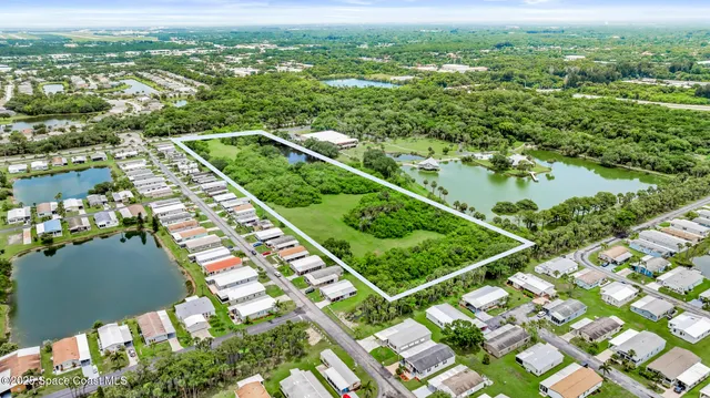 an aerial view of residential house with outdoor space and swimming pool