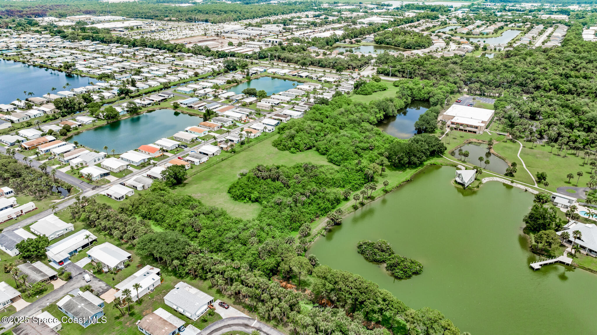 0 South John Rodes Boulevard Melbourne, FL 32934 - Photo 7 of 14 a view of residential houses with outdoor space and trees all around