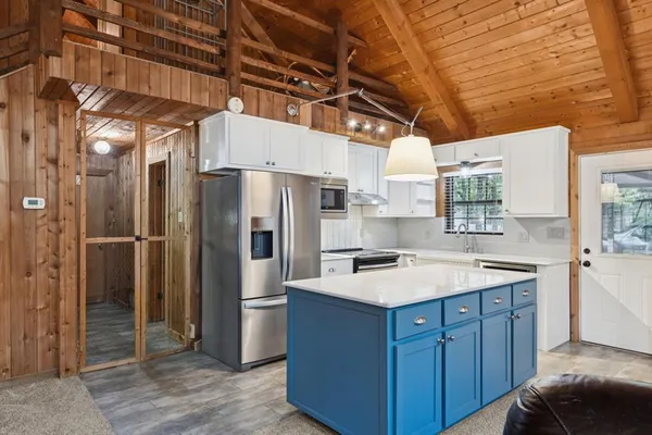 a kitchen with a sink a refrigerator and washer