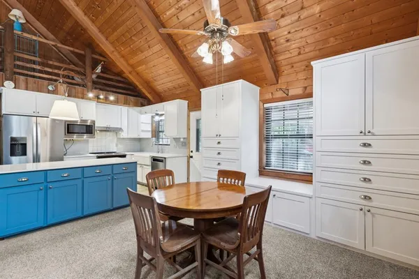 a kitchen with a table chairs and microwave