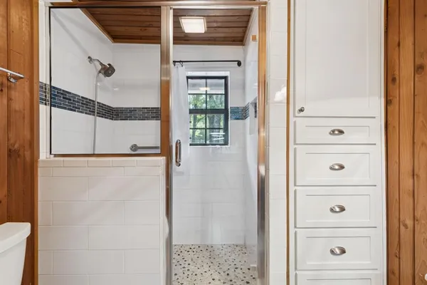 a view of walk in closet and bathroom