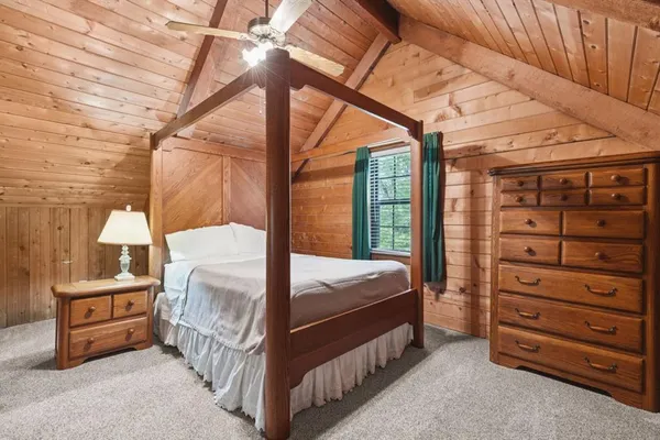 a bedroom with a bed a mirror and shower