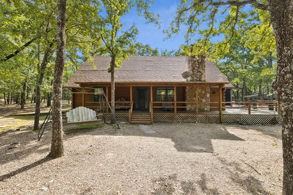 a view of a house with a backyard and sitting area