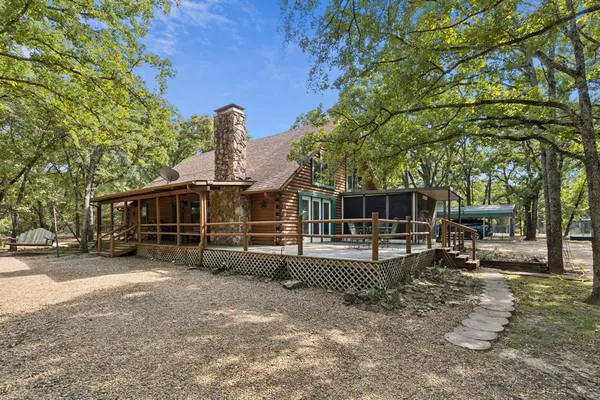 a view of a house with a yard and sitting area