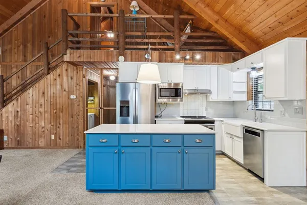 a kitchen with cabinets and white appliances