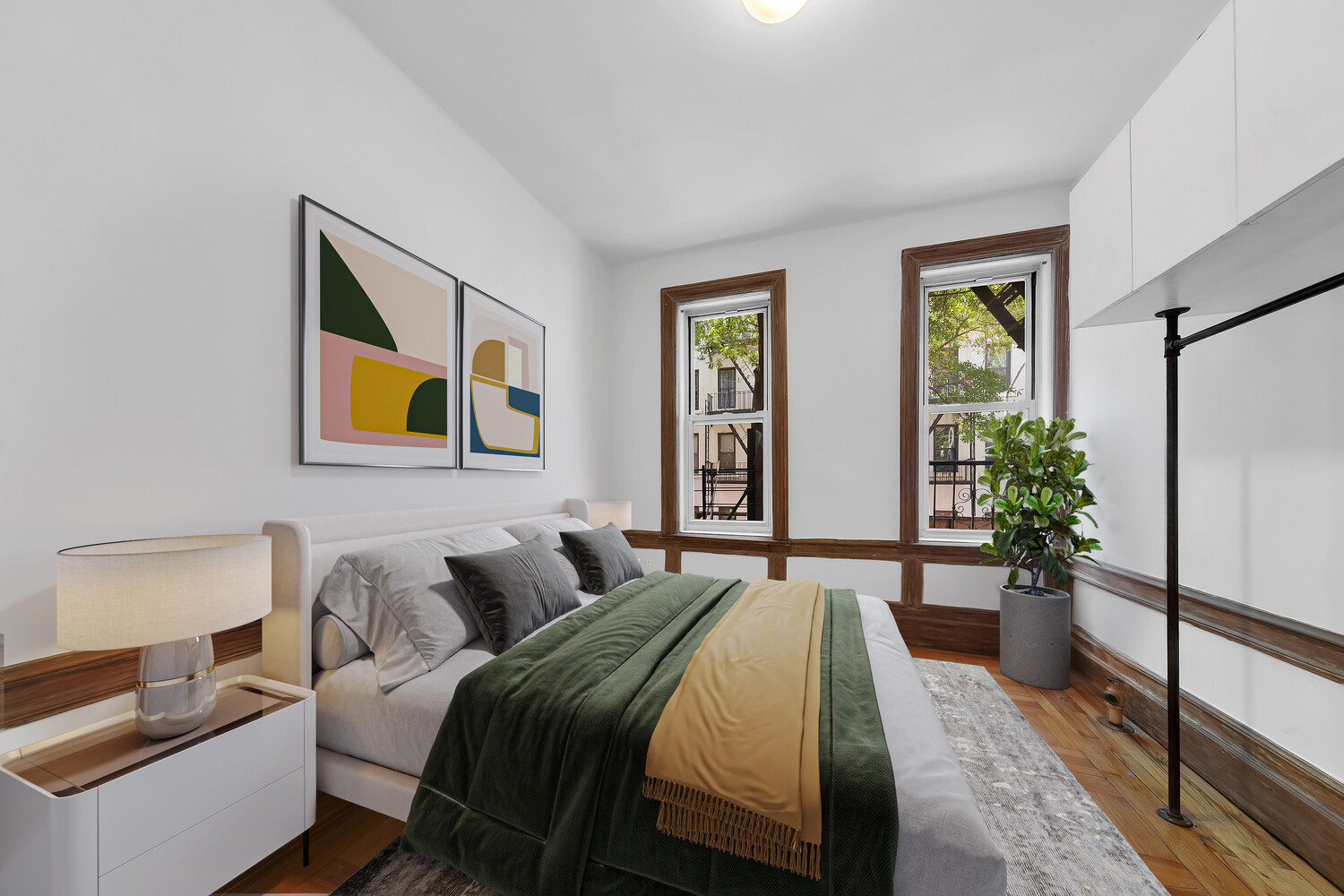 261 West 22nd Street, Unit 11 Manhattan, NY 10011 - Photo 3 of 10 a bedroom with a bed and a painting on the wall